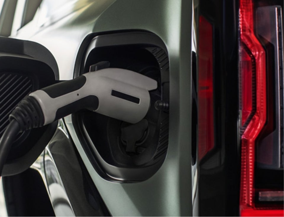 Close up of charging port with charger plugged in on a GMC Hummer EV SUV - CBG GMC, Inc. in DERIDDER LA